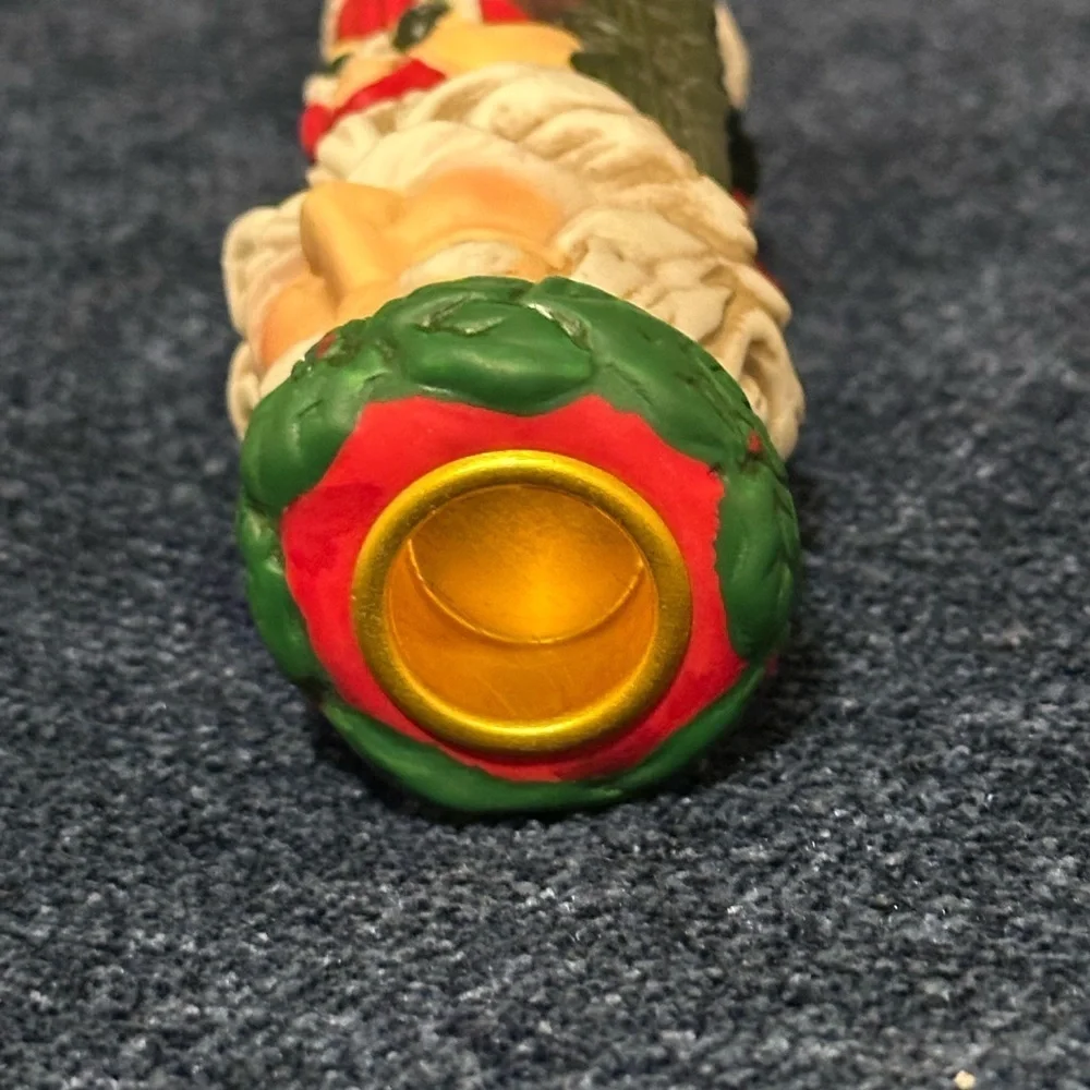 Set of 2 Santa candleholders. Each has smaller different smaller Santas.